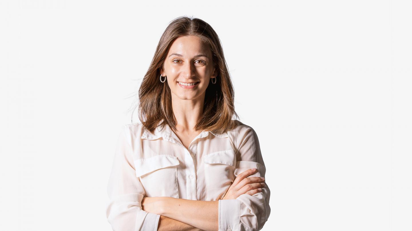 A headshot of a female dancer in a white shirt