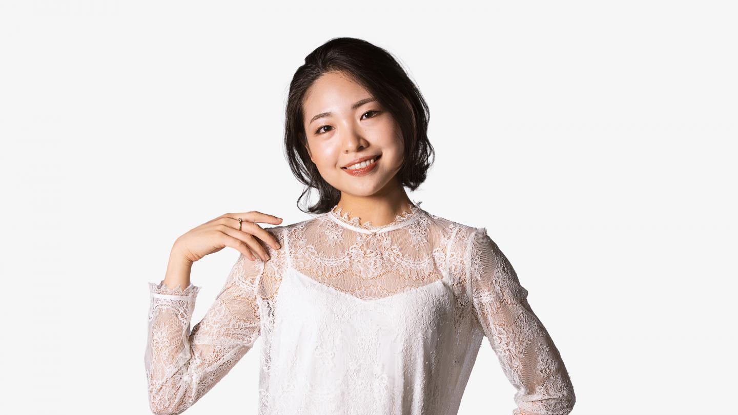 Headshot of a female dancer in a white shirt