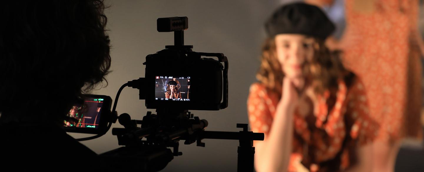 Girl poses in front of a camera