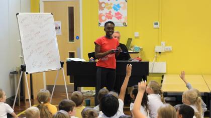 Staff member presenting to school children