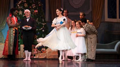 Clara holds her toy nutcracker doll she has received for Christmas