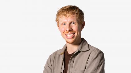 Headshot of a male dancer in a grey shirt