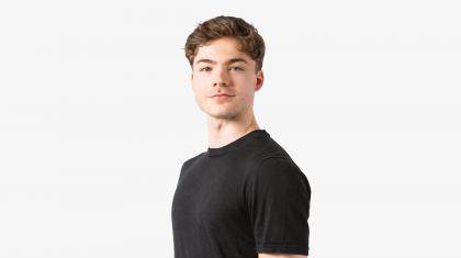 A headshot of a man looking forward in a black t shirt