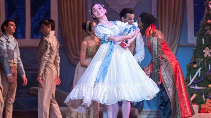 Female dancer in the Nutcracker holding a Nutcracker doll